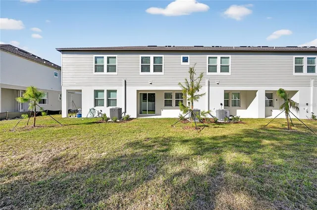 a view of a house with a yard patio and swimming pool