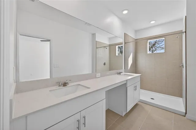 a bathroom with a sink double vanity and a mirror