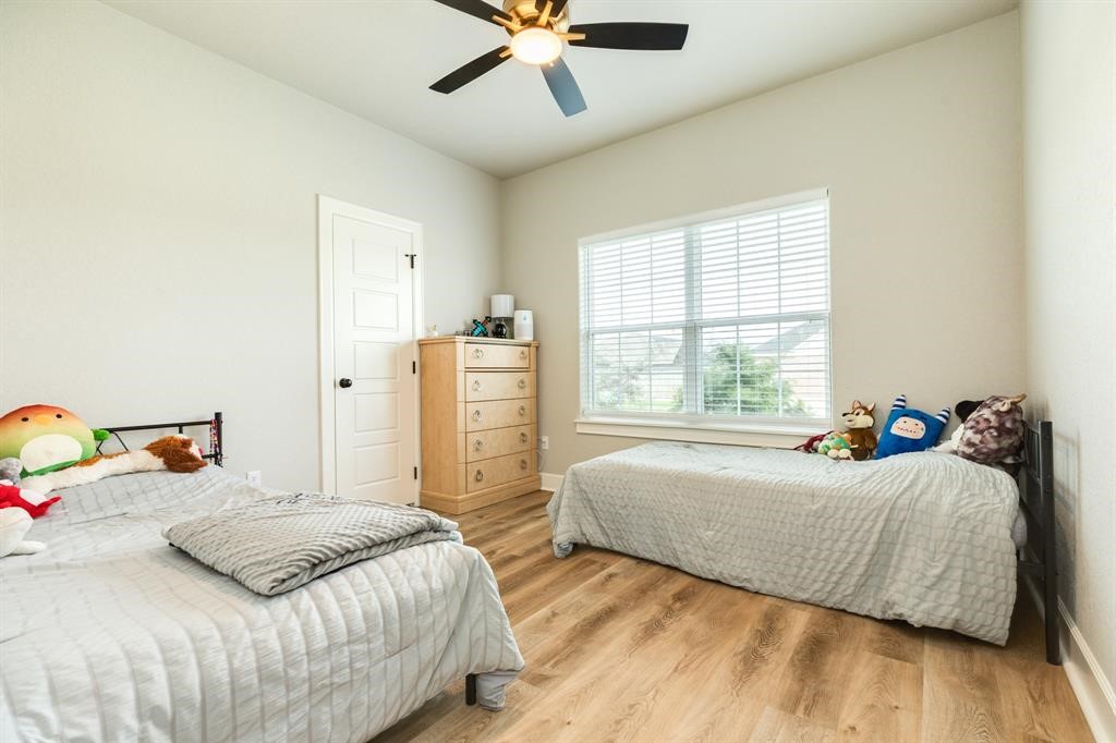 628 Greystone Lane Angleton, TX 77515 - Photo 25 of 33 a bedroom with a bed and window