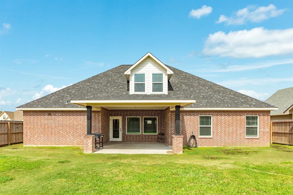 628 Greystone Lane Angleton, TX 77515 - Photo 32 of 33 a front view of a house with a garden and yard