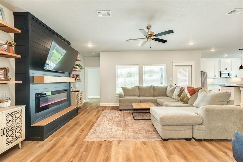 628 Greystone Lane Angleton, TX 77515 - Photo 8 of 33 a living room with furniture and a fireplace