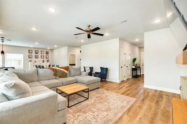 a living room with furniture a ceiling fan and a rug