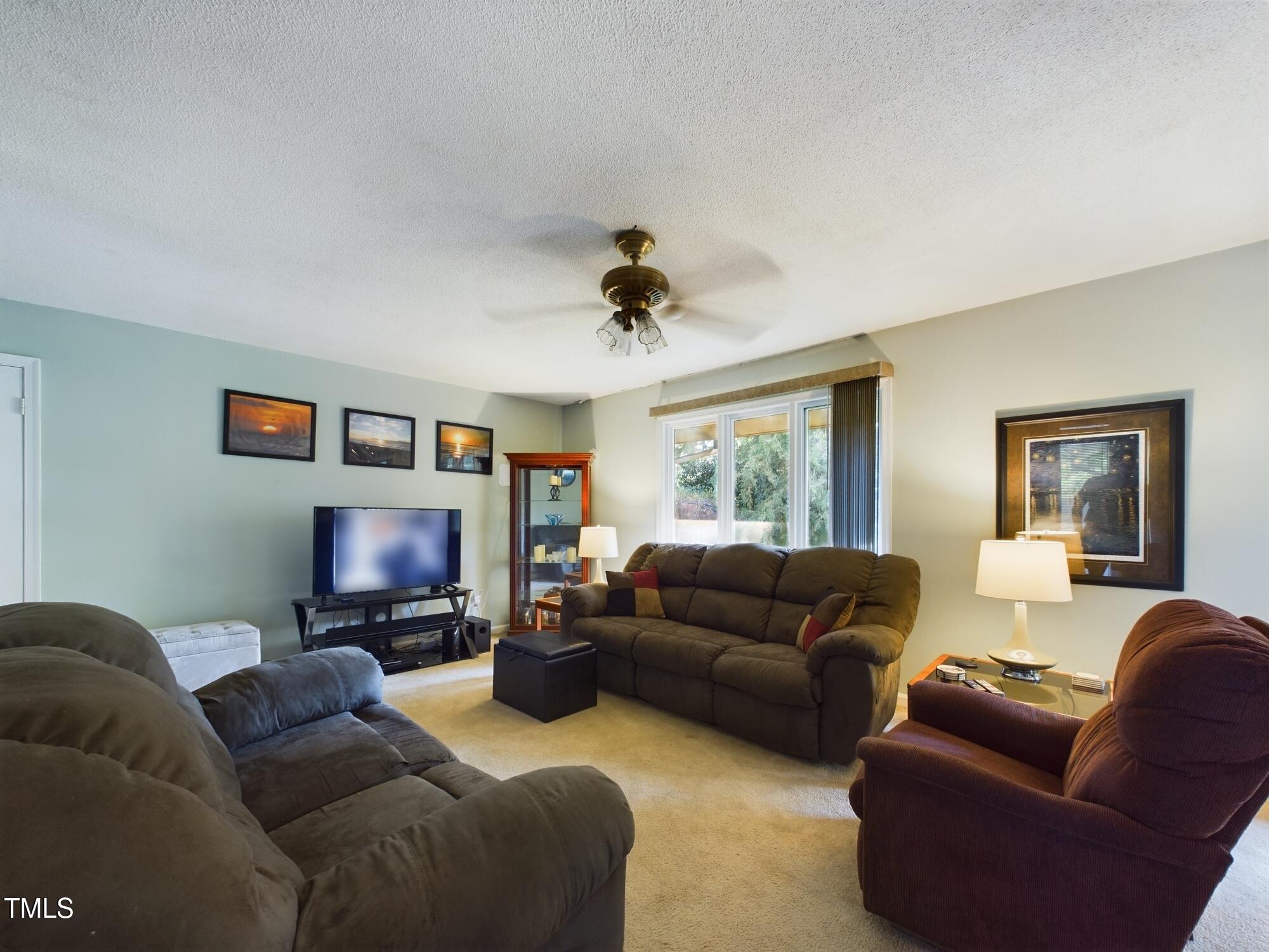 4005 Sherlock Court Raleigh, NC 27613 - Photo 10 of 49 a living room with furniture and a flat screen tv