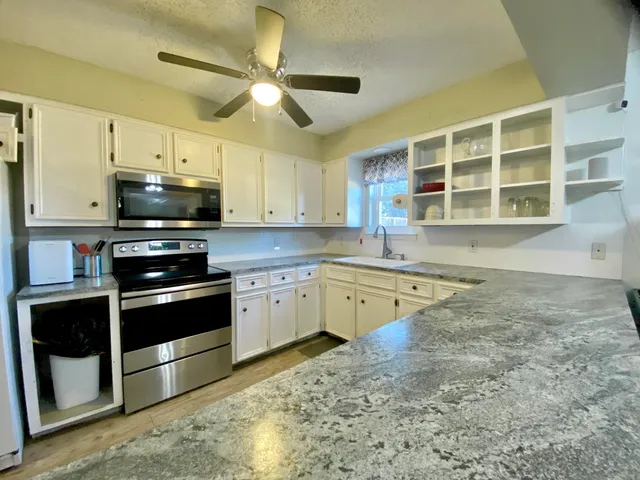 a kitchen with stainless steel appliances granite countertop a stove and a sink