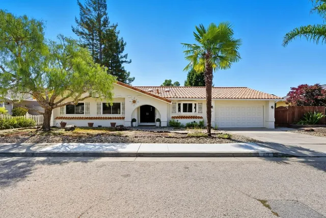 a front view of a house with a space and trees