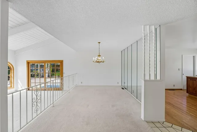 a view of a bedroom with wooden floor windows and fireplace