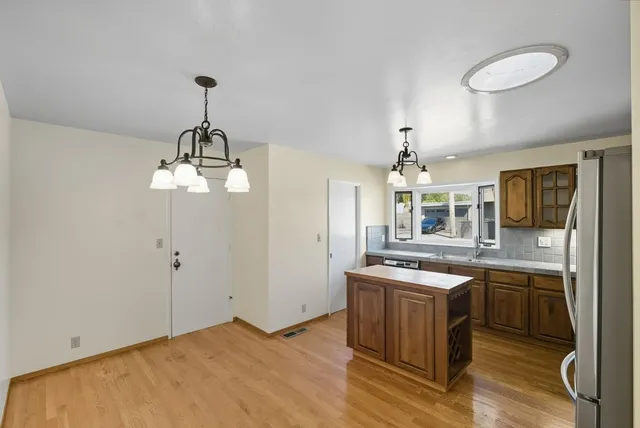 a kitchen with stainless steel appliances granite countertop a sink stove and refrigerator