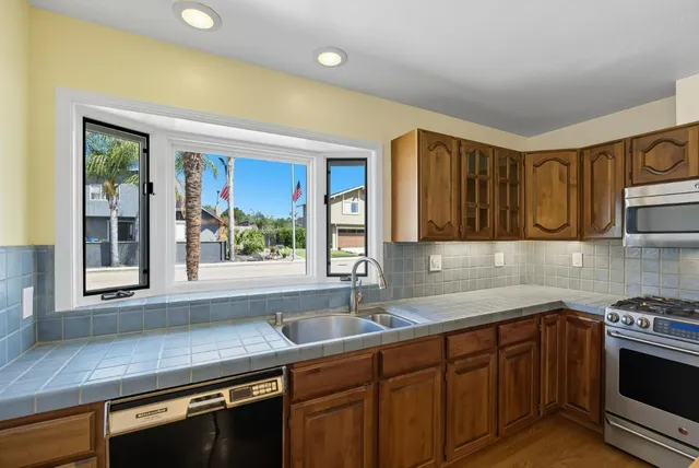 a kitchen with a sink and large window