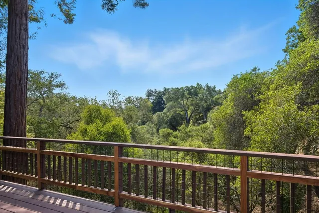a view of a balcony with wooden fence and floor