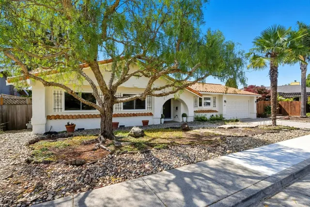 a house that has a tree in front of it