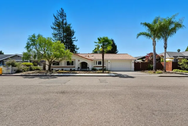 a front view of a house with a yard and a garage