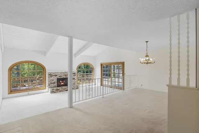 an empty room with windows and outdoor view