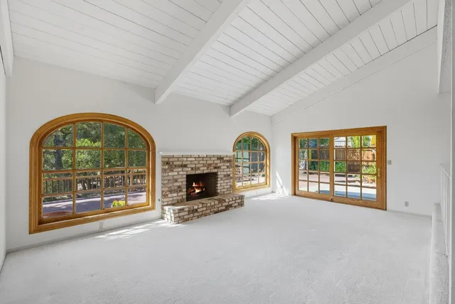 an empty room with furniture and a fireplace