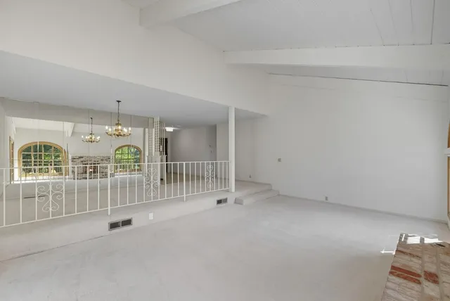 a view of an empty room with stairs