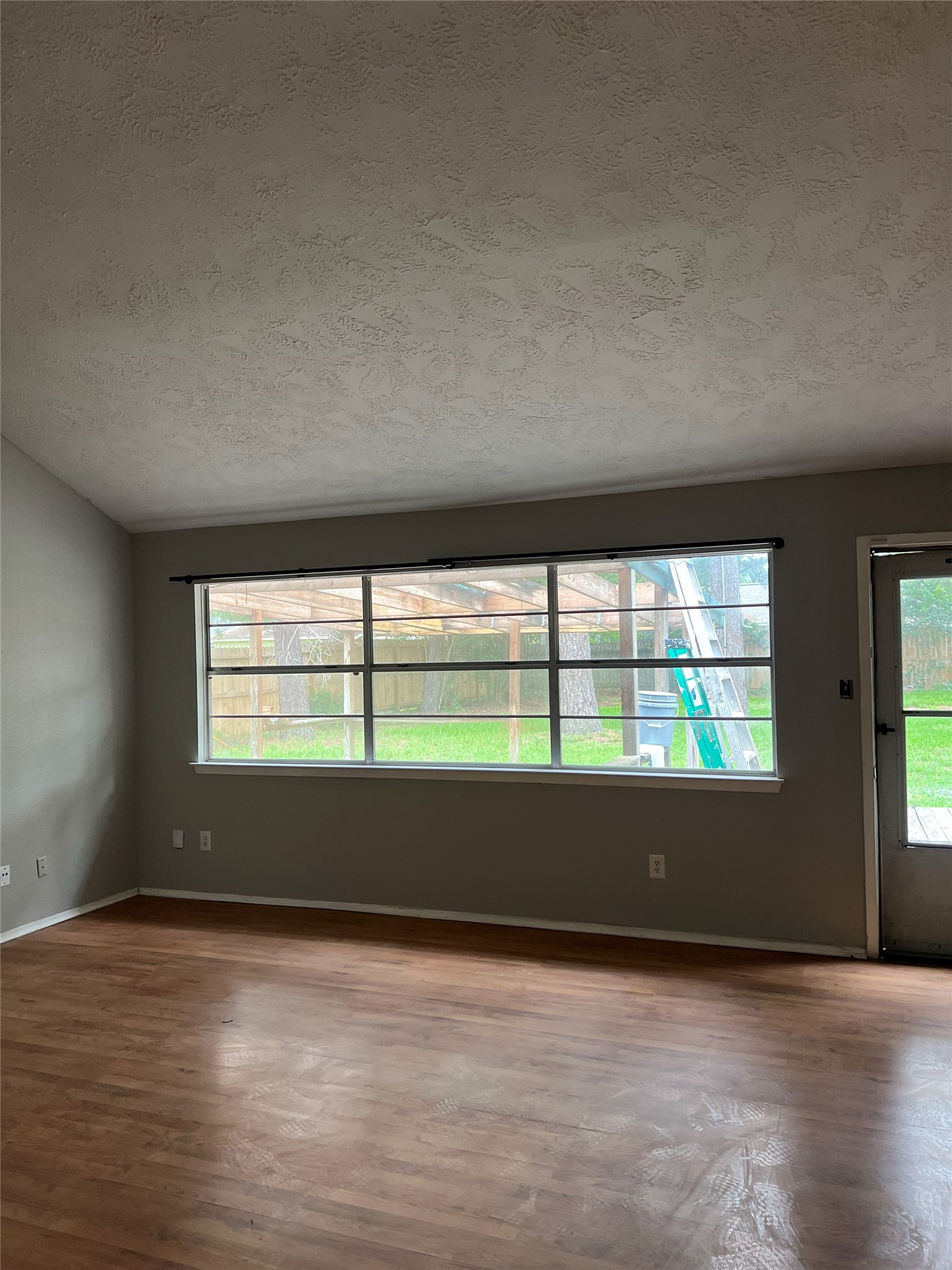6507 Bridgegate Drive Spring, TX 77373 - Photo 2 of 17 an empty room with wooden floor and windows