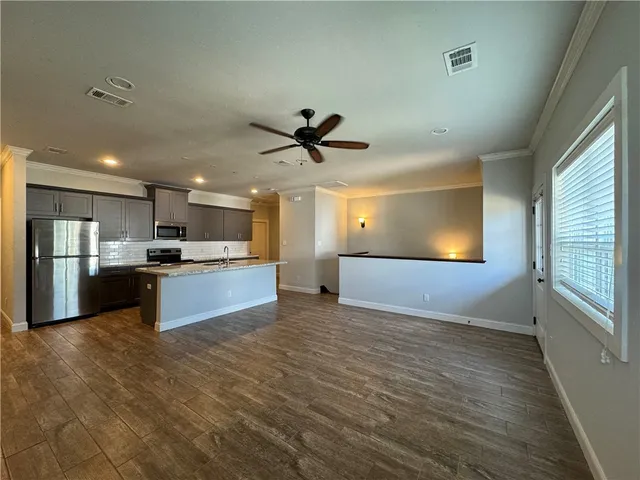 a view of kitchen with refrigerator microwave and stove
