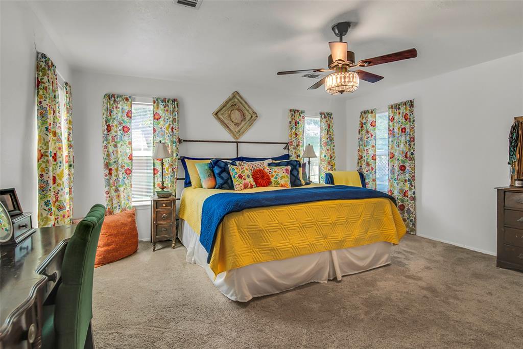 182 Douglas Street Van Alstyne, TX 75495 - Photo 11 of 23 a bed sitting in a bedroom next to a window