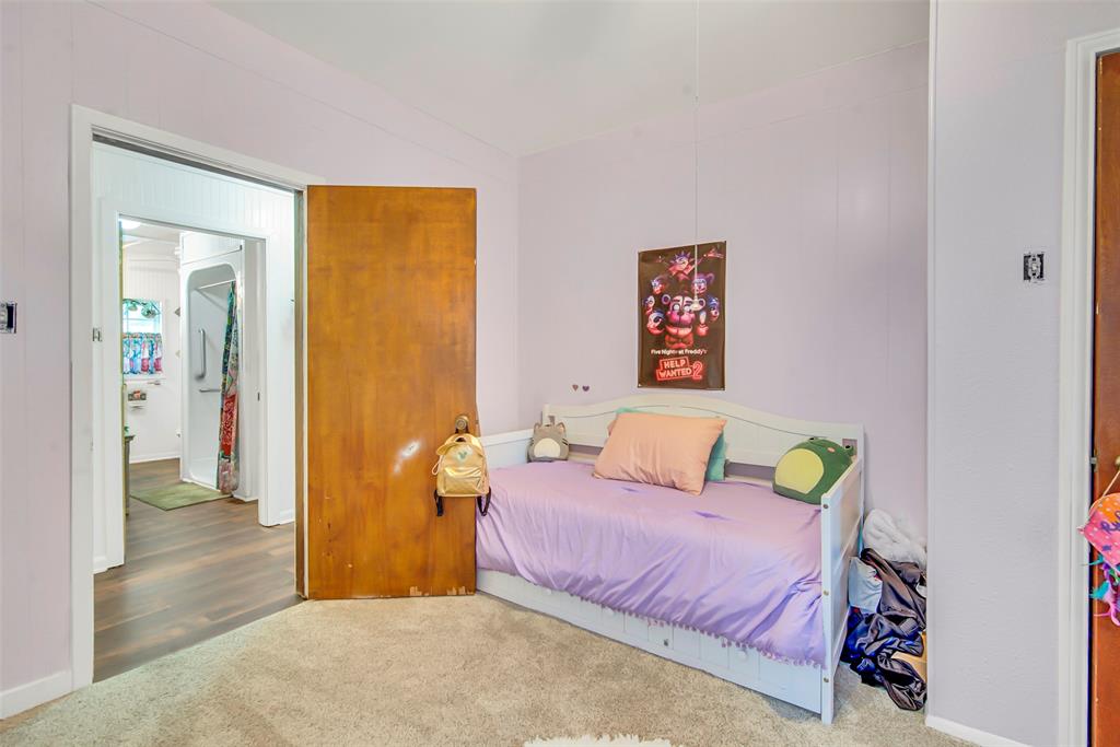 182 Douglas Street Van Alstyne, TX 75495 - Photo 15 of 23 a bedroom with a bed and a painting on the wall