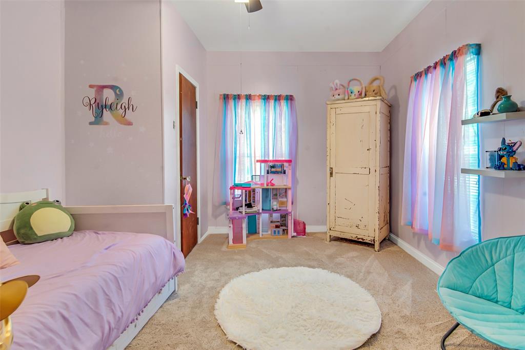 182 Douglas Street Van Alstyne, TX 75495 - Photo 16 of 23 a bedroom with bed and cabinets