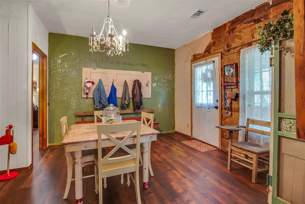 182 Douglas Street Van Alstyne, TX 75495 - Photo 18 of 23 a view of a dining room with furniture wooden floor and chandelier
