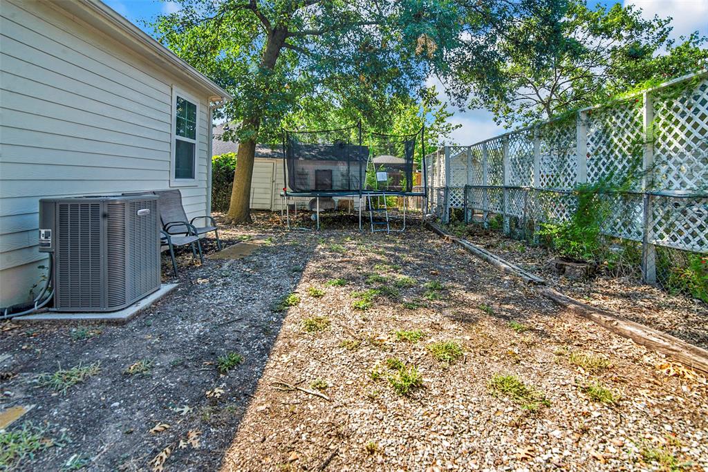 182 Douglas Street Van Alstyne, TX 75495 - Photo 19 of 23 a view of a yard with a house and a large tree