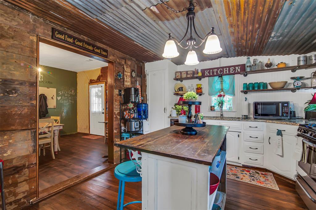 182 Douglas Street Van Alstyne, TX 75495 - Photo 22 of 23 a kitchen with stainless steel appliances granite countertop a stove and cabinets