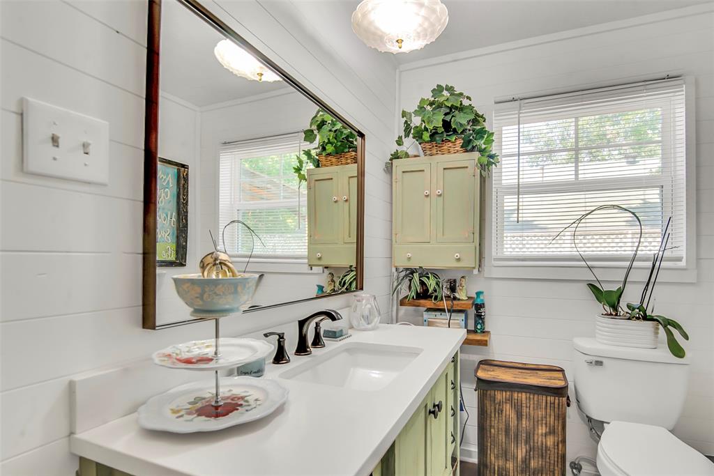 182 Douglas Street Van Alstyne, TX 75495 - Photo 7 of 23 a bathroom with a double vanity sink and a mirror