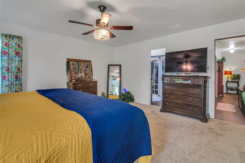 182 Douglas Street Van Alstyne, TX 75495 - Photo 9 of 23 a bedroom with a bed and a television