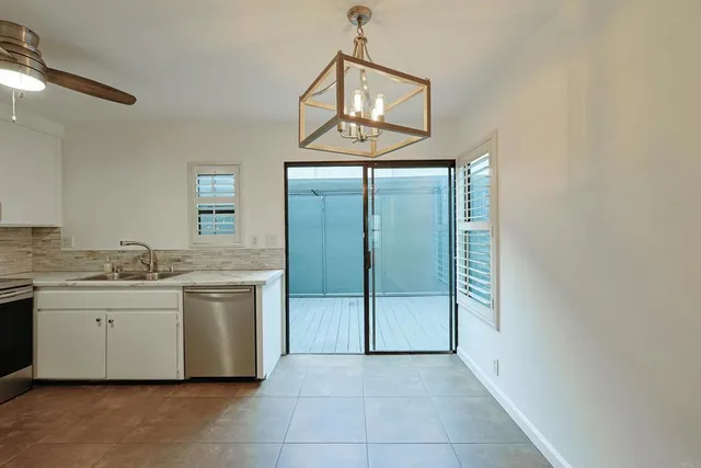 a view of a bathroom with mirror and sink