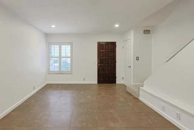 an empty room with windows and closet