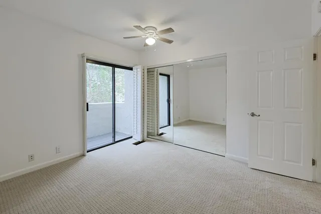 an empty room with fan and a ceiling fan