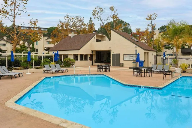 a swimming pool view with a outdoor seating