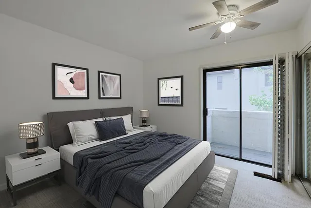 a bedroom with a large bed and a chandelier