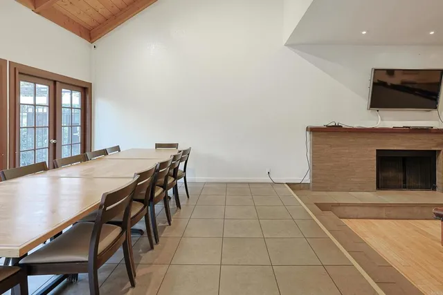 a view of a dining room with furniture and a fireplace