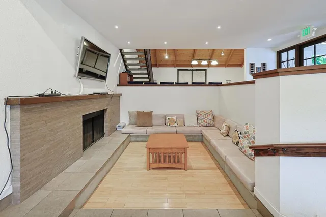 a lobby with a fireplace furniture and a flat screen tv