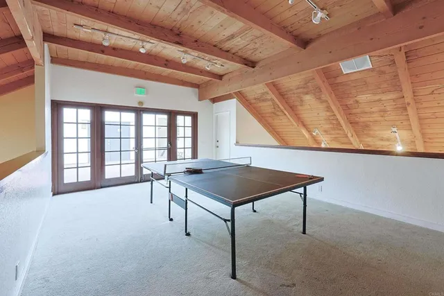 a room with a table chair and a large window