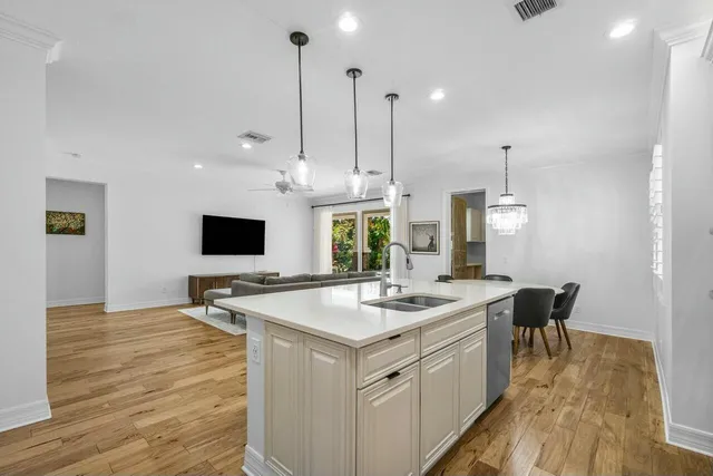 a kitchen with a sink counter and chairs