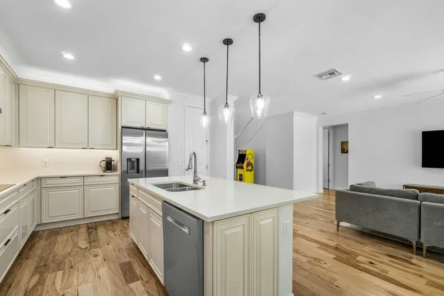 a kitchen that has a lot of cabinets in it and appliances