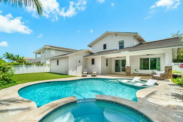 a swimming pool with outdoor seating and yard