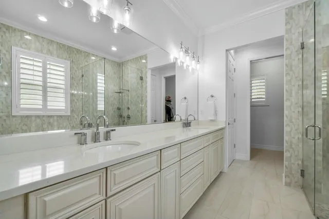 a bathroom with double sink and a mirror