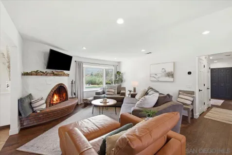 a living room with kitchen island furniture and a chandelier