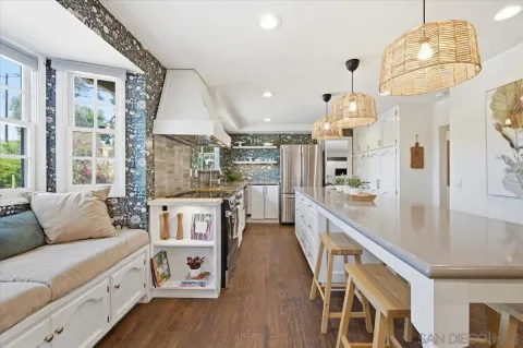a large kitchen with stainless steel appliances a large center island attached withe living room