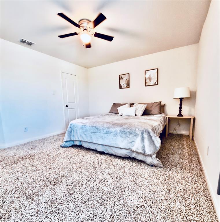 196 Cattlemans Crk Road West Newark, TX 76071 - Photo 17 of 31 Carpeted interior space featuring a ceiling fan with integrated lighting, a solid panel door, and white walls