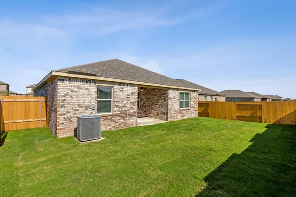 a front view of house with yard and outdoor seating