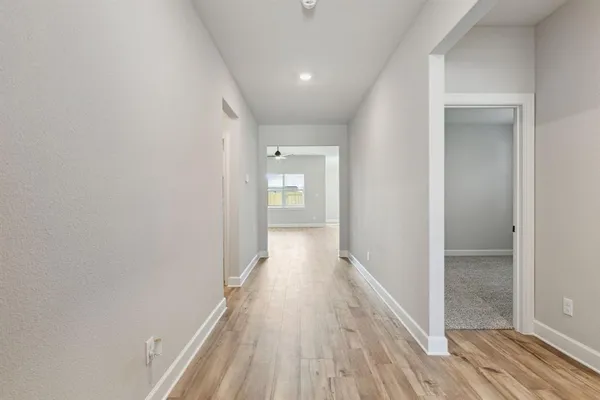 a view of hallway with wooden floor