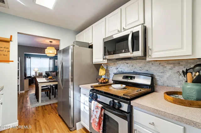 a kitchen with granite countertop a stove and a sink