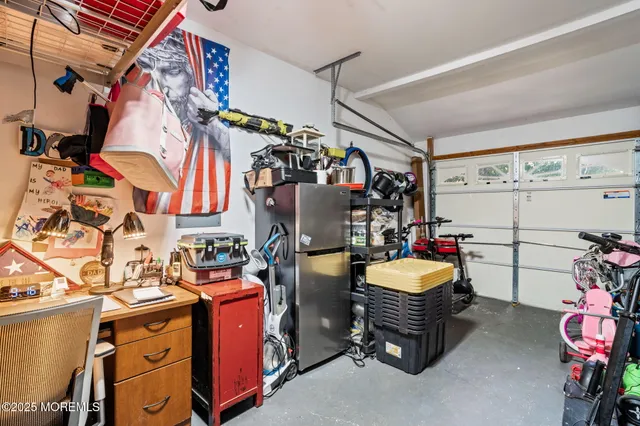 a view of a hallway to a livingroom with wooden floor and white walls