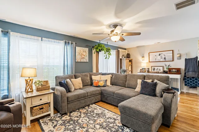a living room with furniture ceiling fan and a rug