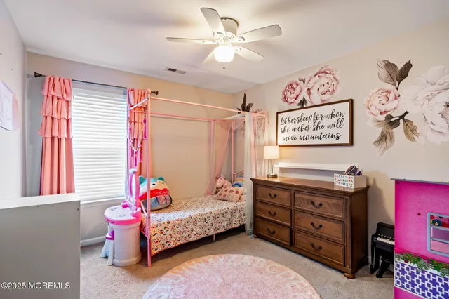a bedroom with furniture and a flat screen tv