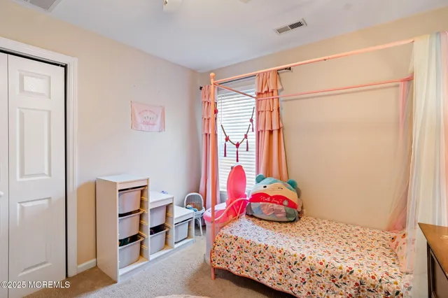 a bedroom with a bed and a flat screen tv in it